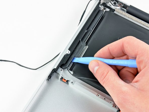 Image 2/2: Pry up along the edge of the right speaker until it is separated from the upper case.