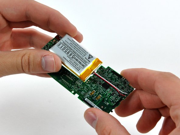 Rotate the battery toward the logic board and place it flat in its void, bending the cables as necessary.