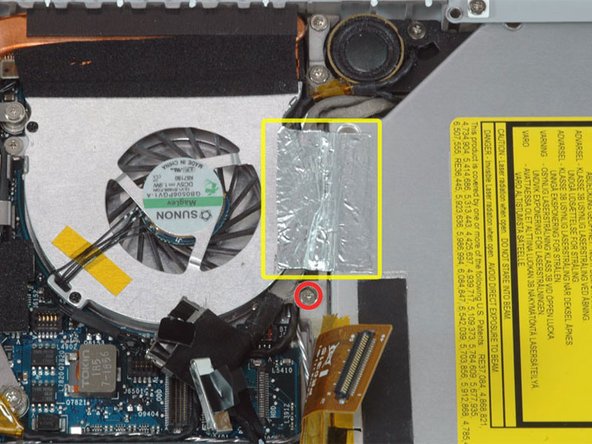 Peel up the foil tape between the fan and the optical drive.