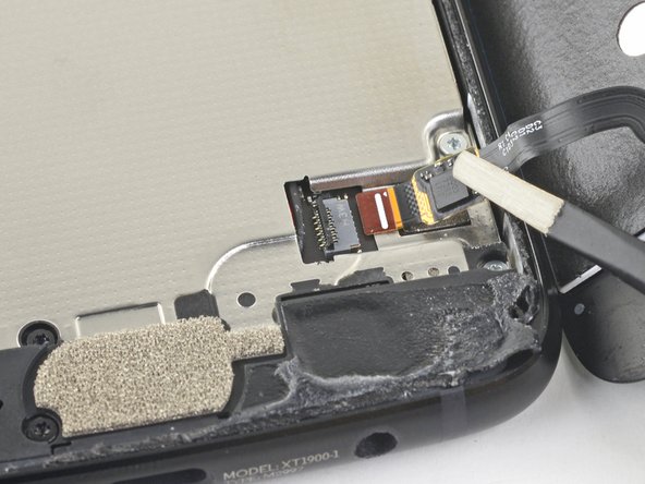 Use tweezers to carefully slide the fingerprint sensor cable out of the socket.