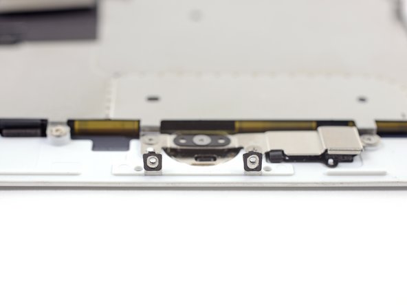 iPhone 7 / 7 Plus only: Before installing your display, check the condition of the black gaskets on the two small screw bosses on the bottom edge of your display, near the home button.