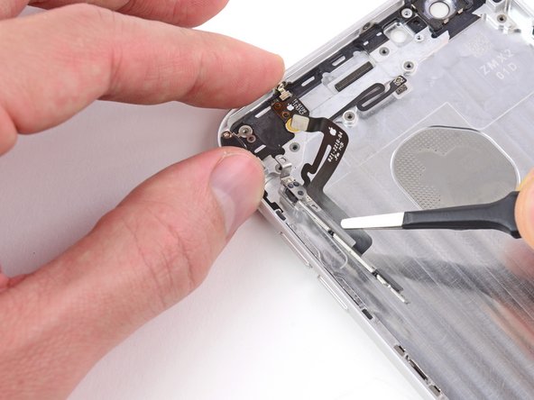 Image 3/3: Peel with care. The cable is secured to the rear case with mild adhesive.