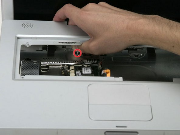 Image 1/1: Lift the upper case enough to disconnect the blue and white power cable from the logic board.