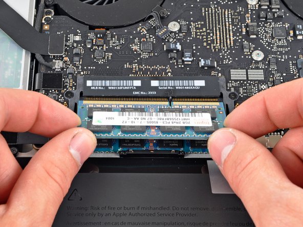 Image 3/3: Repeat this process if a second RAM chip is installed.