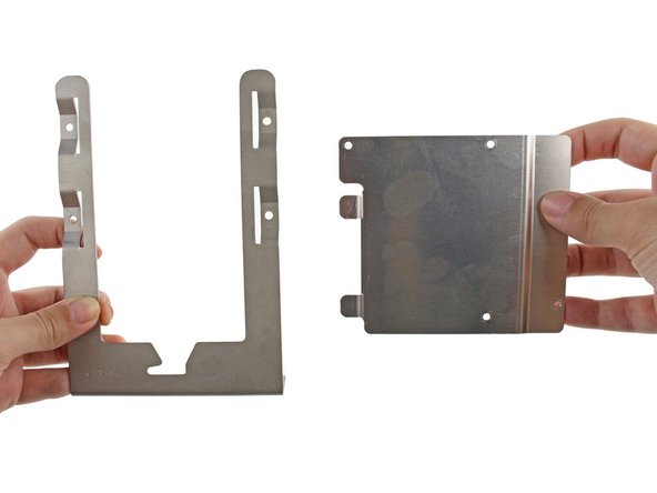 Insert the two tabs on the left side of the metal adapter bracket into the slots on the left side of the hard drive bay sled.