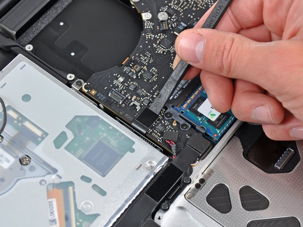 Image 1/1: Fold the optical drive cable back to keep it out of the way of the logic board.