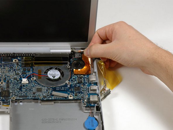 Image 1/1: Peel up and remove the orange foil shield near the right speaker.