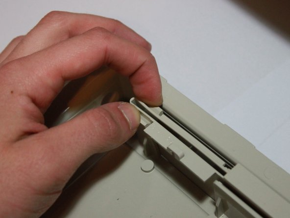 Image 3/3: Lift the foot up and away from the case. It should easily separate into two parts.