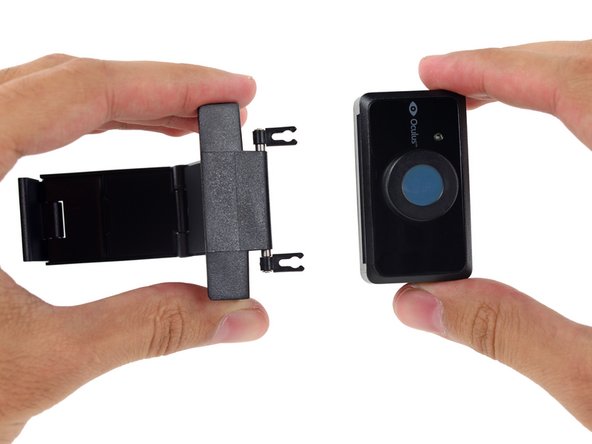 Image 2/2: The positional camera itself is attached to its stand with two small clips. Once detached, we're free to crack it open to find the real goodies inside.