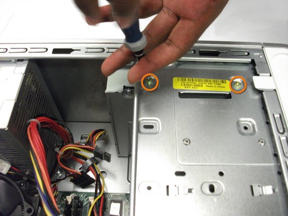 Image 1/1: Locate and remove the two Phillips #0 7.8 mm screws.