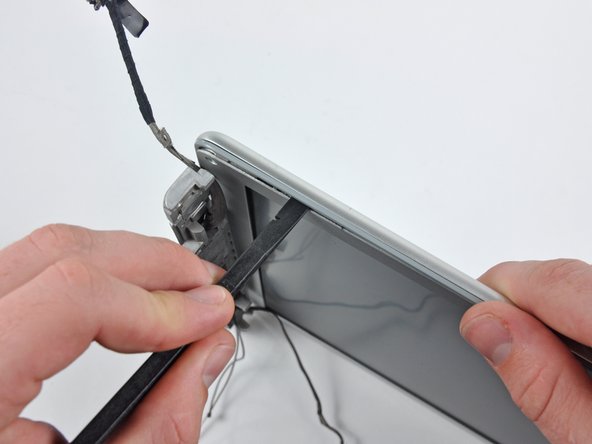 Image 1/3: Rotate the tool away from the LCD to pop the rear bezel off the tabs on the front display bezel.