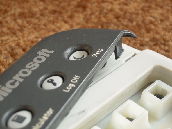 Image 3/3: Remove the upper button assembly.