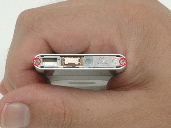 Remove the two Phillips #00 screws from the top of the iPod.