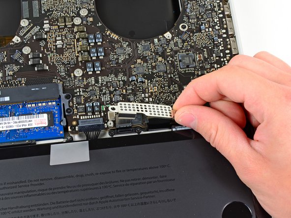 Image 2/2: Lift the cover off the logic board and set it aside.