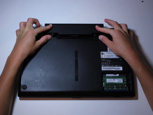 While doing this, slide the battery out.