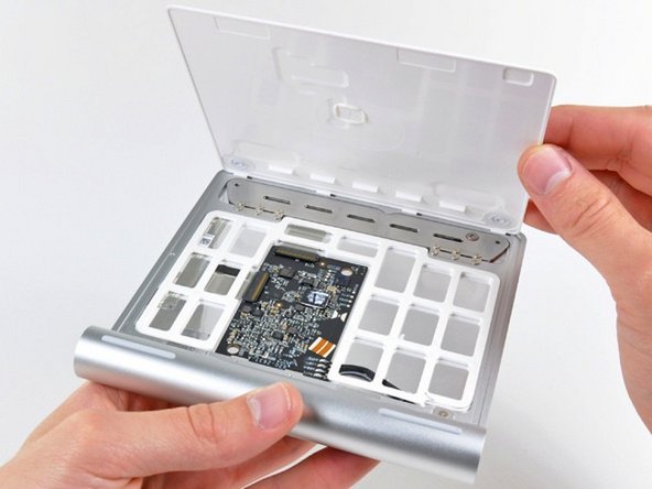 Image 2/2: After slicing through most of the adhesive, the lower panel lifts right off.