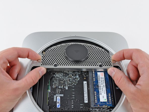 Image 2/2: Do not remove the antenna plate yet. It is still attached to the AirPort/ Bluetooth board.