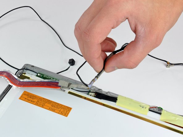 Image 2/2: Remove the display data cable from the display.