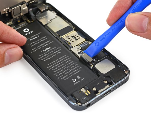 Use a plastic opening tool to gently pry the battery connector up from its socket on the logic board.