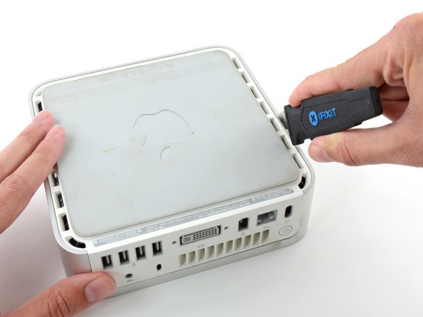 Insert the Jimmy into the crack between the aluminum top housing and the plastic lower housing.