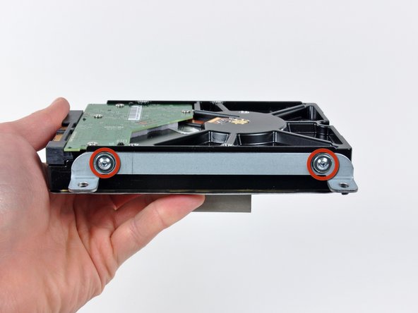 Image 1/1: Remove the upper bracket from the hard drive.