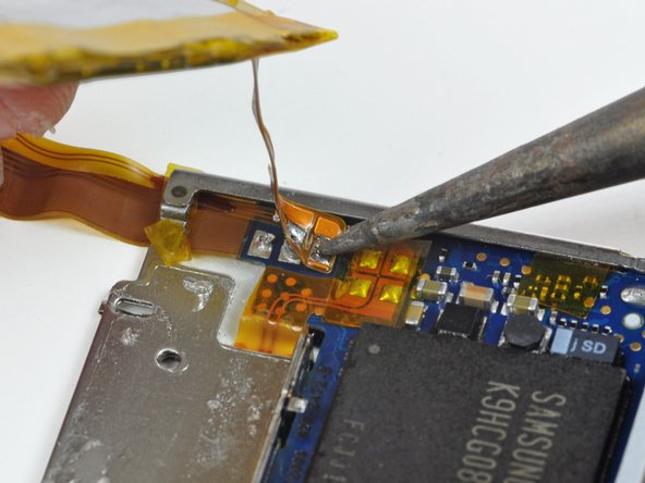 Image 2/2: Lift the old battery out of the nano and set it aside.