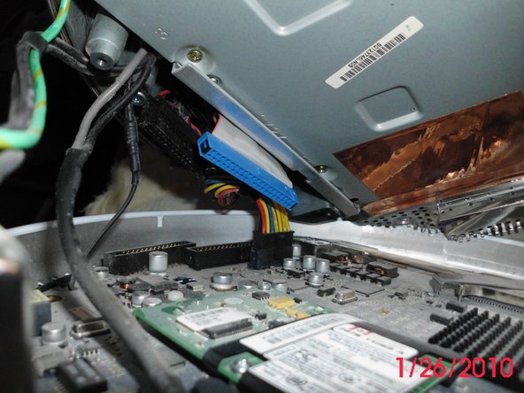 Image 1/2: Locate the 3.6 volt 1/2 AA Lithium PRAM battery on the logic board and replace it.