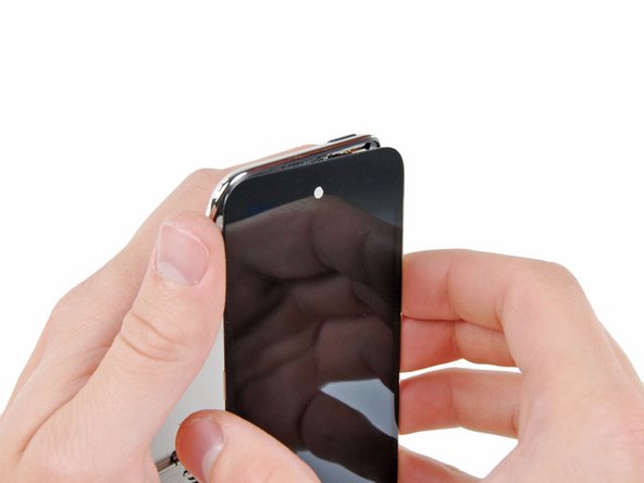 Image 1/2: Also, the display data cable is very short and is connected to the logic board near the top of the front panel assembly. If it does not become disconnected while freeing the top edge of the front panel assembly, be sure to disconnect it with an iPod opening tool before rotating the front panel assembly out of the Touch.