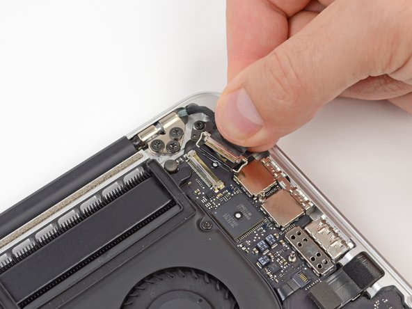 Image 3/3: Do not lift up on the display data cable, as its socket is very fragile. Pull the cable parallel to the face of the logic board.