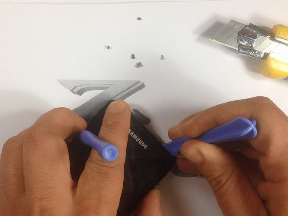 With a cutter, make a room for a plastic tool, then continue with separating the Touchscreen &amp; LCD Display from the frame.