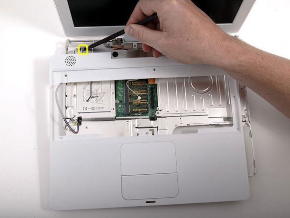 Image 1/1: Lift the upper case enough to disconnect the blue and white power cable from the logic board. Using your fingernails or a dental pick, carefully pry the connector from its socket. Make sure you're pulling only on the connector and not on the socket.