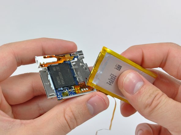 Image 2/2: Pry the battery off the adhesive securing it to the metal tray on the logic board.