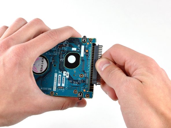 Image 1/1: This is a bit tricky. Try rocking the connector gently from side to side while applying even pressure. If you bend the pins, do your best to straighten them, using the hard drive cable as a guide.