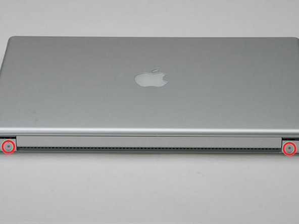 Image 1/1: Close the display and turn the hinge side of the computer to face you.