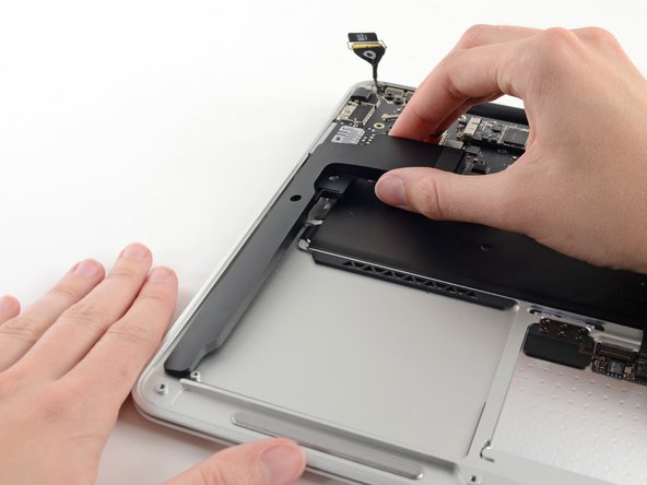 Image 3/3: Remove the right speaker from the upper case.