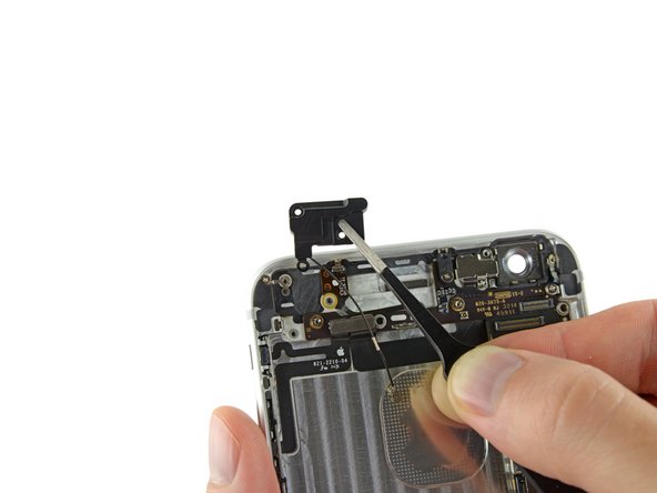 Image 1/2: During reassembly, make sure to place the small washer in the top left corner of the antenna assembly.