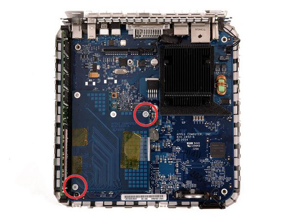 Remove the two silver Phillips screws from the corners of the wireless interface board.