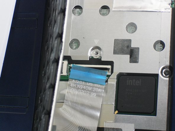 Disconnect the ribbon by lifting the black plastic hinge and removing the clear blue cable.