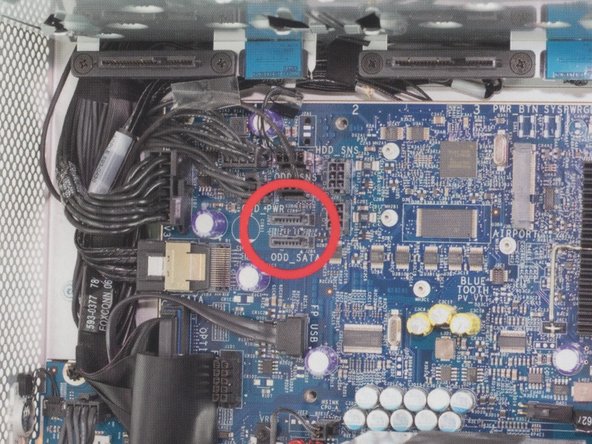 Image 1/2: Insert the L shaped SATA cable into the top SATA port on the logic board.