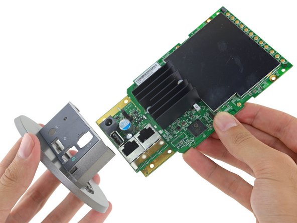 Image 3/3: It looks like the heat sink actually draws heat ''through'' the motherboard—we spy the real heavy ~~hitters~~ heaters on the reverse.