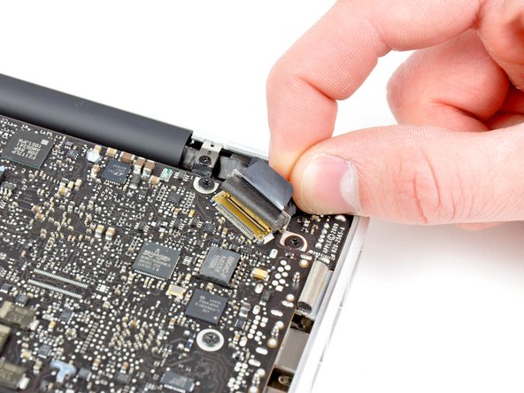 Image 3/3: Do not lift up on the display data cable, as its socket is very fragile. Pull the cable parallel to the face of the logic board.