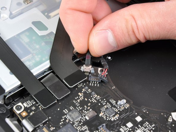 Image 1/1: Pull the cable parallel to the face of the logic board. Pulling the cable upward may damage the logic board or the cable itself.
