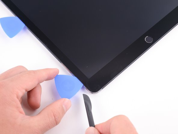 Insert a pick in the bottom left corner of the iPad to ensure that the adhesive doesn't completely reset.