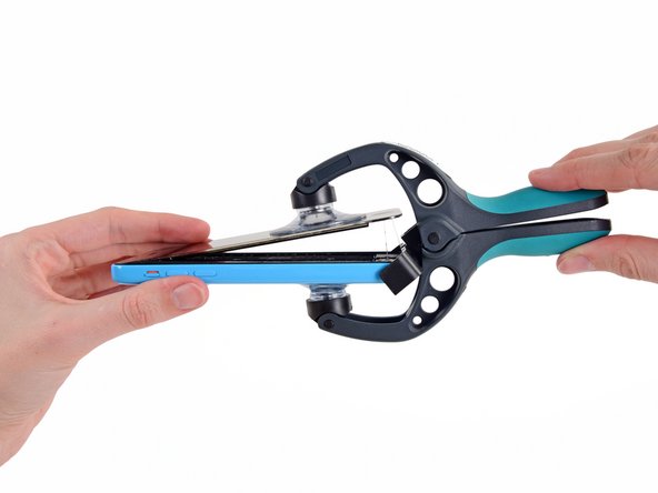 Image 2/2: Peel the two suction cups off your iPhone.