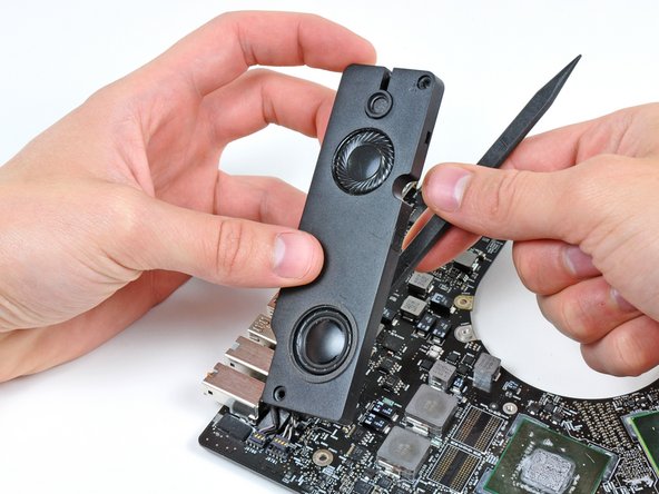 Image 2/2: Use the flat end of a spudger to lift the left speaker and microphone connectors out of their sockets on the logic board.