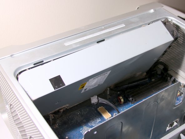 Image 1/2: Do not completely remove the power supply since it is still attached to a cable.