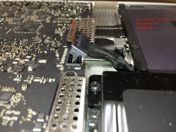 Image 3/3: Pull the tab parallel to the face of the logic board.