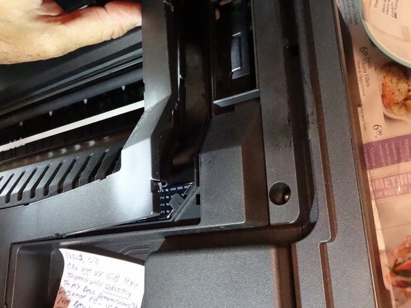 Remove the cover on the right side exposing the ribbon cable gently use the spudger in the tabs to release it