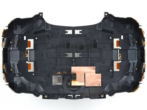 Image 3/3: Hiding in the back of the assembly, we find a couple spring contacts that deliver power to the whole setup—and behind that swath of copper tape, the camera.