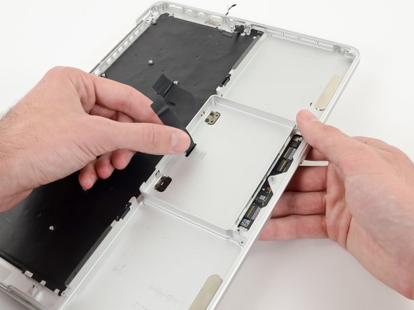 Image 1/2: Remove the trackpad from the upper case.